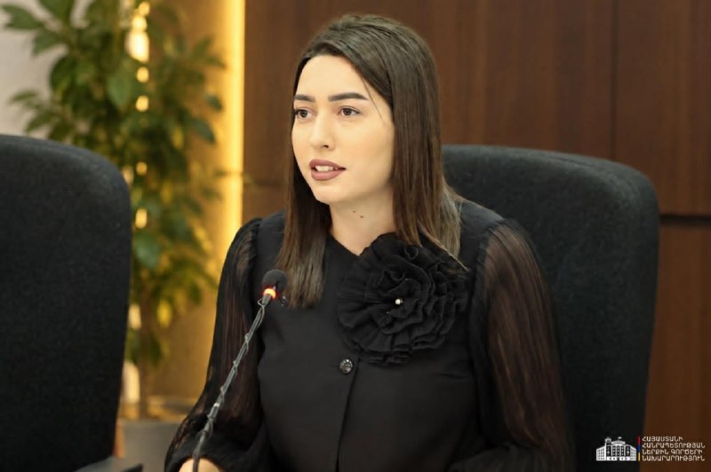 Арпине Саргсян, министр внутренних дел Армении, на фоне флага Армении
